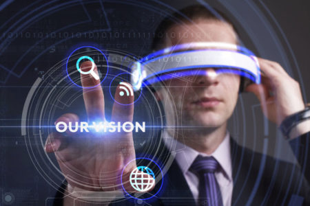 72429720 - business, technology, internet and network concept. young businessman working in virtual reality glasses sees the inscription: our vision